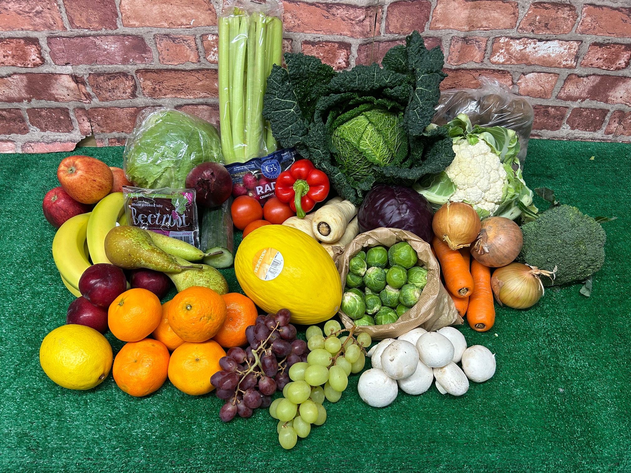 A £40 mixed box of fruit, salad and vegetables laid out on a table